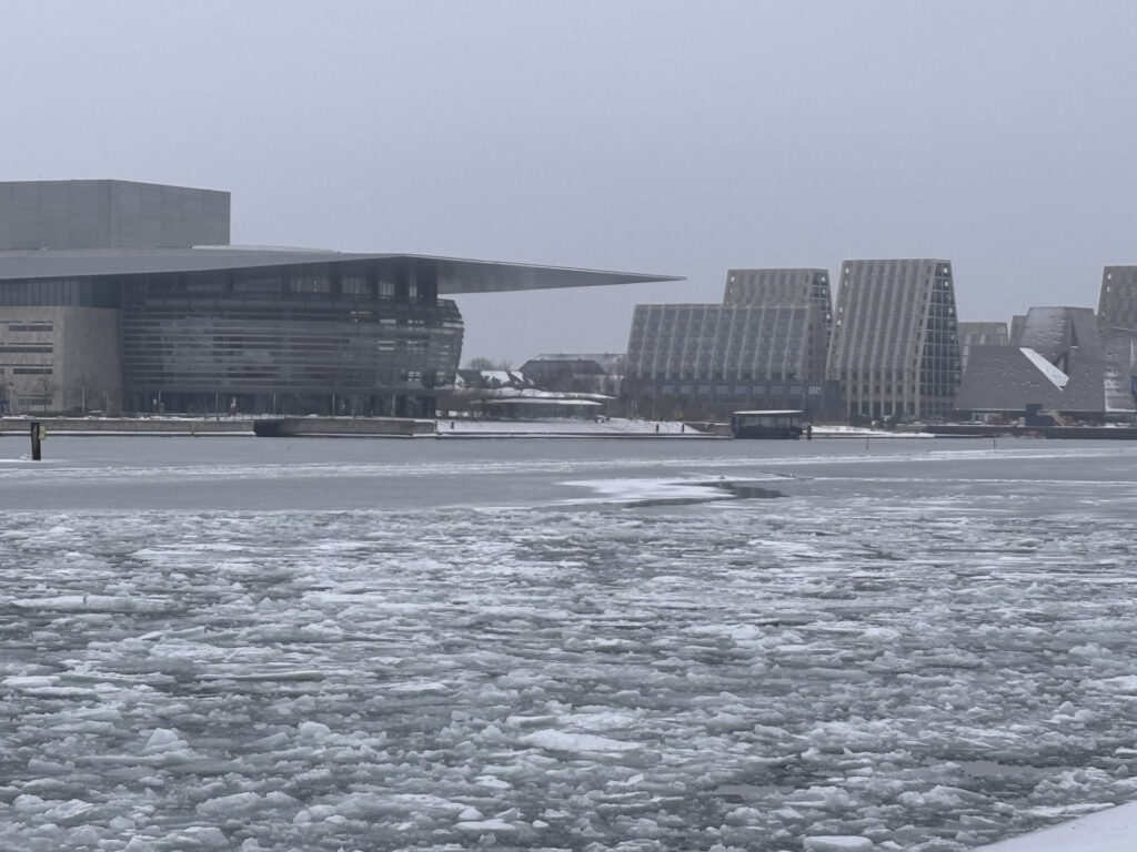 Operaen og havnebyggeriet i København set over drivis en gråvejrsdag om vinteren.